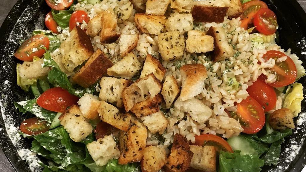 Mediterranean Salad · Romaine lettuce, whole grain brown rice, cucumbers, tomatoes & house made croutons with lemon pepper, garlic herb seasoning & house made red wine vinaigrette [V]