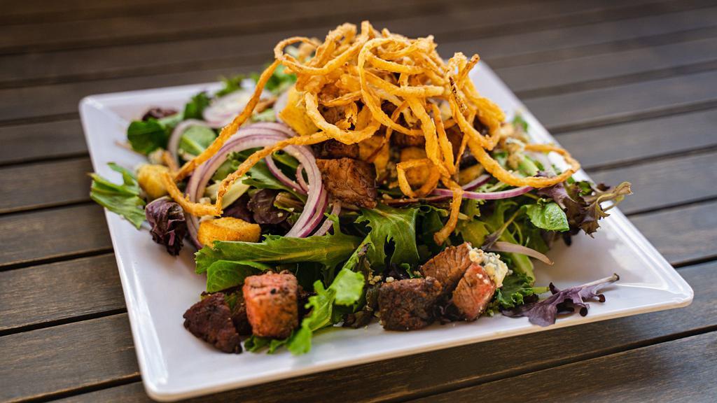 Steak · Mixed greens, smoked tri tip, bleu cheese crumbles, red onions, balsamic dressing and topped with onion strings.