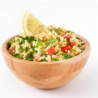 Large Tabbouleh Salad · Finely chopped parsley tossed with mint, onions, bulgar, tomatoes, and fresh squeezed lemon ...
