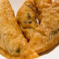 Gyoza · Vegetable dumpling deep fried.
Those inside are bean curds, not the meats.