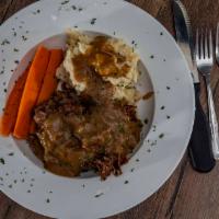 Yankee Pot Roast · Caramelized onion gravy with braised carrots, garlic mashed potatoes and a ramekin  horserad...