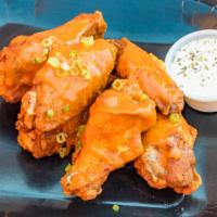 Classic Buffalo · 8 traditional wings tossed in classic buffalo (medium heat), served with  a dipping sauce of...