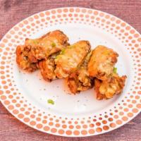 Garlic Parmesan · 8 traditional wings tossed in garlic parmesan (mild heat), served with  a dipping sauce of y...