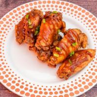Classic Bbq · 8 traditional wings tossed in BBQ (mild heat), served with  a dipping sauce of your choice.
