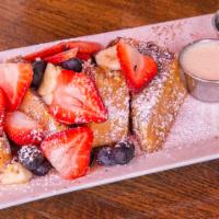 Crunchy French Toast · French Toast rolled in crunchy corn flakes topped with Bananas and Berries served with Vanil...