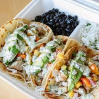Mahi Mahi Tacos · Corn tortillas willed with grilled Mahi-Mahi on a bed of shredded cabbage and topped with ma...