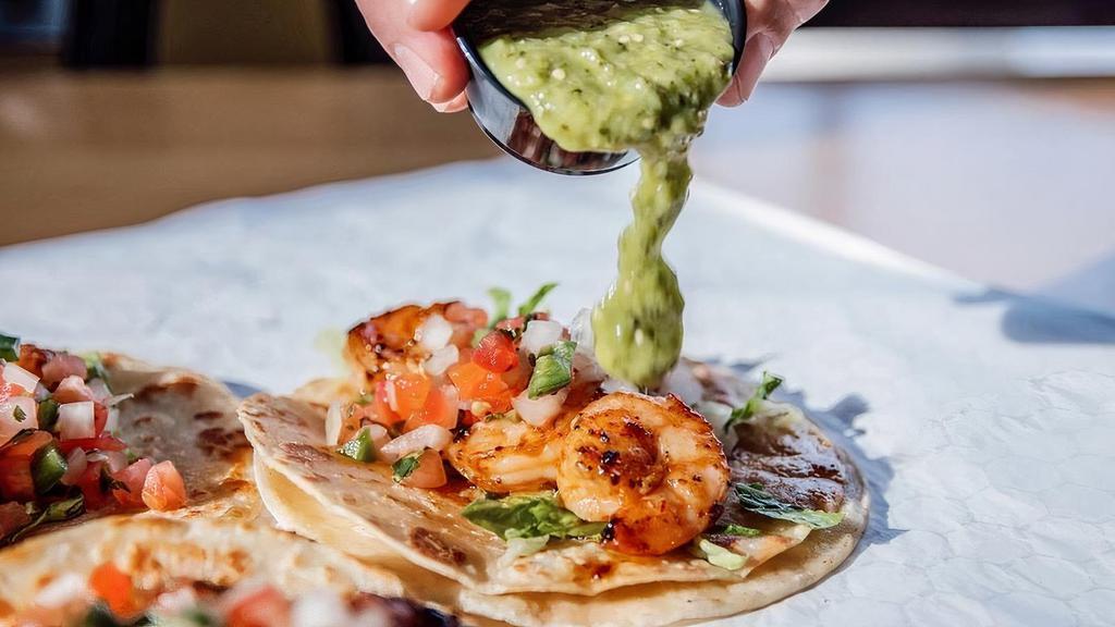 Chipotle Shrimp Tacos · Corn tortillas filled with our chipotle shrimp on a bed of romaine lettuce topped with pico de gallo and salsa verde. Comes with your choice of rice and beans.