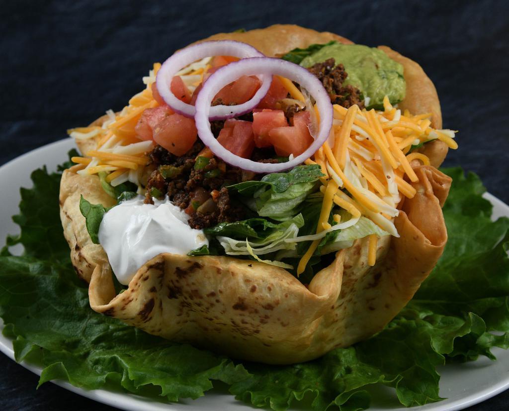 Taco Salad Beef · Sour cream, avocado, Cheddar and Monterey Jack cheese, black olives, corn, tomatoes, tortilla chips, choice of dressing.