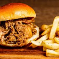 Kalua Pork Sandwich · Hana’s slow roasted pulled pork served on a toasted bun drizzled with teriyaki served with a...