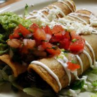 Taquitos Dorados · Three Taquitos, filled with your choice of Beef, Chicken, or Potato with Roasted Poblano Pep...