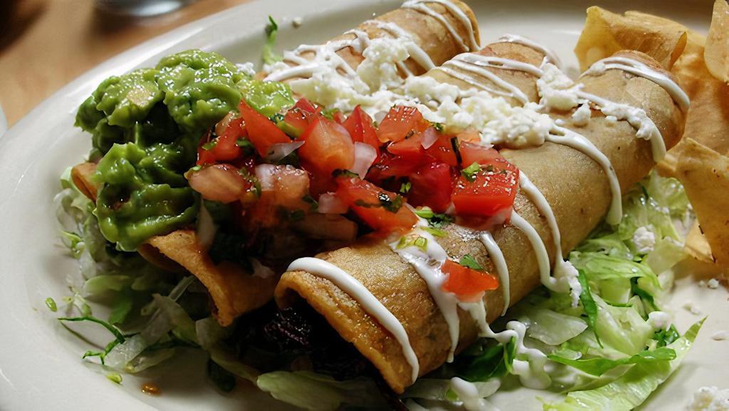 Taquitos Dorados · Three Taquitos, filled with your choice of Beef, Chicken, or Potato with Roasted Poblano Peppers. Crema Mexicana, Queso Fresco, and Guacamole.