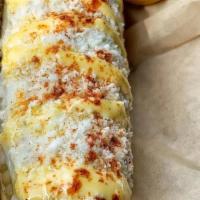 Corn On The Cob / Elote Entero · Mayo, cotija cheese, butter, and chile.