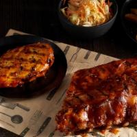 Bbq Chicken & Ribs · A grilled chicken breast and a half rack of Pork Ribs both smothered in our smoky molasses B...