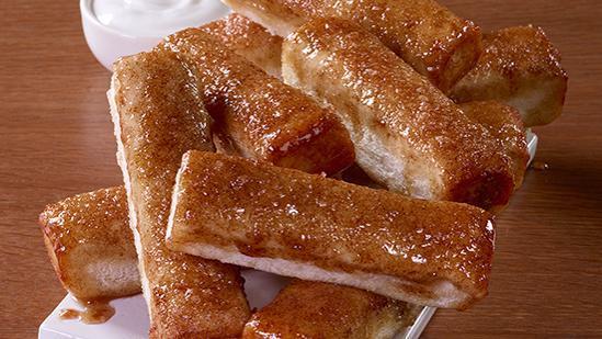 Cinnamon Sticks · Our freshly-baked cinnamon sticks are a sweet finale to pizza night. Don't forget the icing dip for added deliciousness!