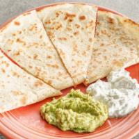 Quesadilla · Beef (shredded or ground), chicken or carnitas; served with sour cream & guacamole.