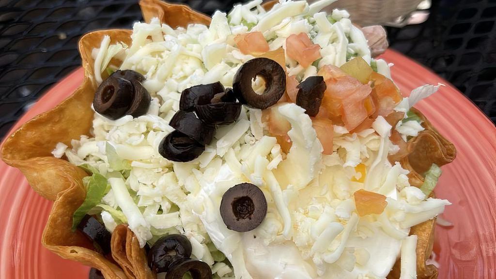 Fiesta Salad · Flour shell filled with beans, choice of meat, lettuce, tomatoes, guacamole, sour cream, cheese and olives.