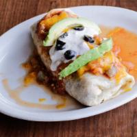 Breakfast Burrito · A large burrito filled with sausage, bacon, onions, chiles and scrambled eggs topped with sa...