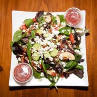 Health Nut Salad · Spring mix, grape tomatoes, feta, green apples, pecans, dry cranberries, and cucumbers with ...