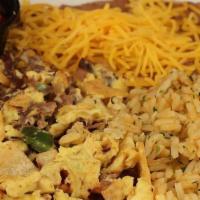 Machaca  · Shredded beef mixed with eggs, green bell pepper, onion blend, tomatoes, tortilla chips, bea...