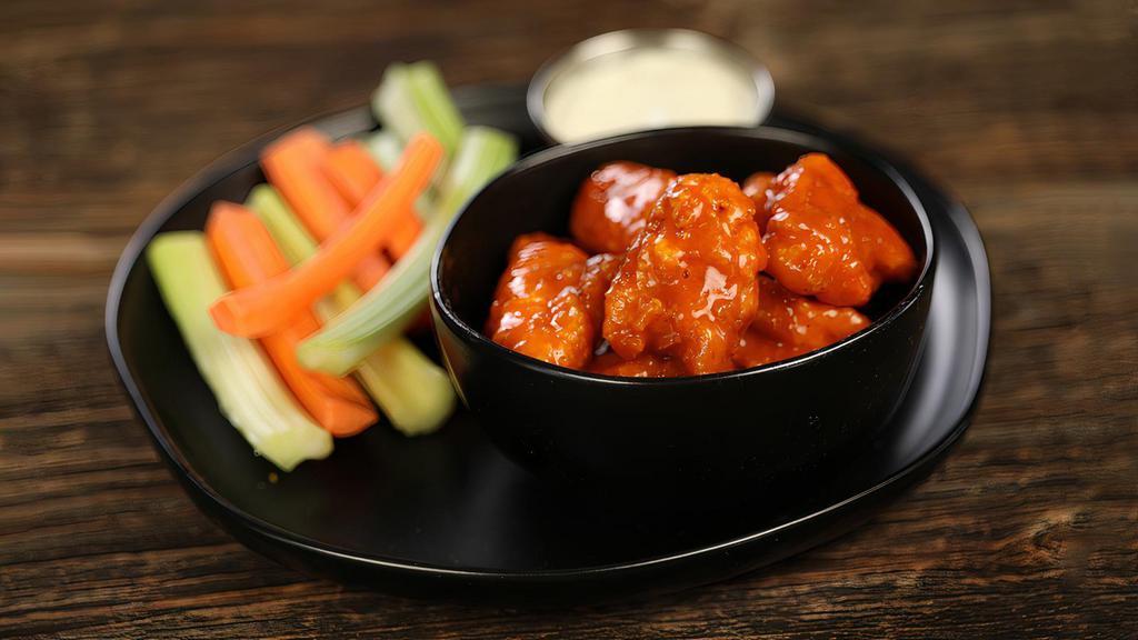 Classic Buffalo · 8 boneless wings tossed in classic buffalo (medium heat), served with carrots & celery and a dipping sauce of your choice.