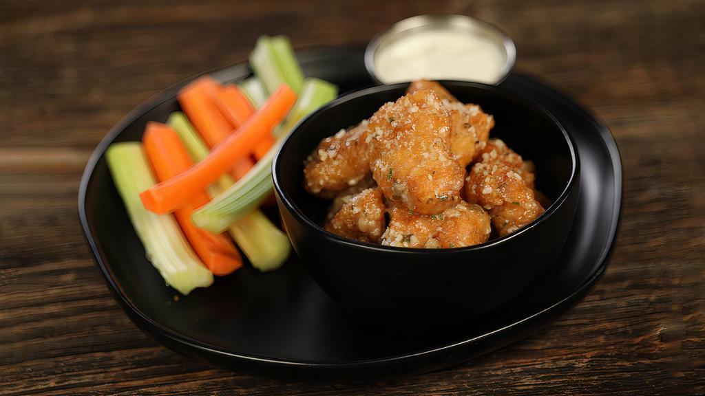 Garlic Parmesan · 8 boneless wings tossed in garlic Parmesan (mild heat), served with carrots & celery and a dipping sauce of your choice.