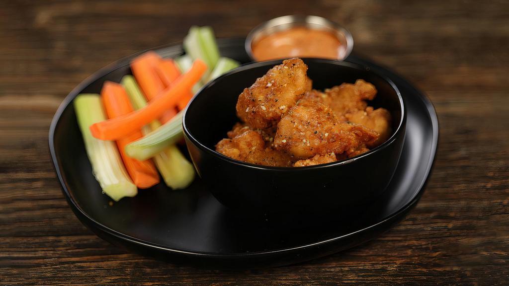 Lemon Pepper - 8 Wings · 8 boneless wings tossed in lemon pepper (mild heat), served with carrots & celery and a dipping sauce of your choice.