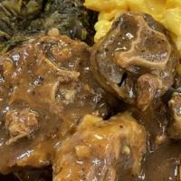 Oxtails · Special cut of premium oxtails with rice and gravy, garnished with herbs and pickled fresno ...