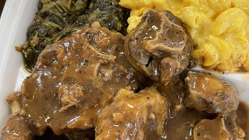 Oxtails · Special cut of premium oxtails with rice and gravy, garnished with herbs and pickled fresno chilis.