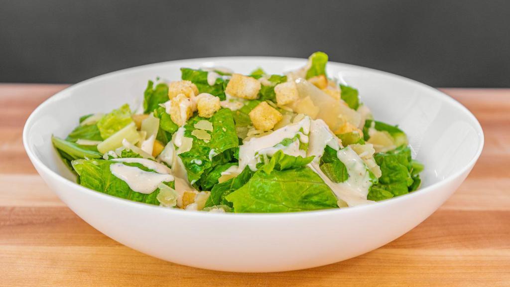 Caesar Salad · Crisp romaine lettuce with shaved parmesan, croutons and caesar dressing.