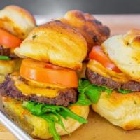 Italian Sliders · Garlic knot buns with beef patties topped with melted cheese, aioli, arugula, and roma tomato.