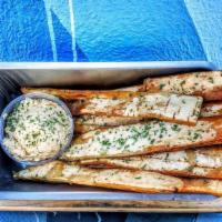 Fried Pita Strips With Hummus · Lightly fried pita strips tossed in our secret seasoning and parsley. Served with Hummus on ...