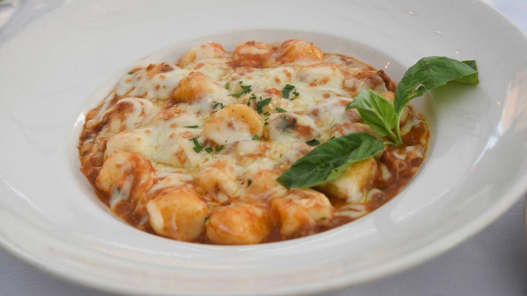 Gnocchi Sorrentina · A unique delicacy brought from Sorrento. Homemade potato dumplings with Mozzarella and Parmesan cheeses in a meat sauce.