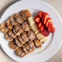 Nutella Pancakes · Strawberry, banana, Nutella and powdered sugar.