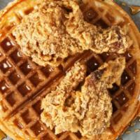Famous Chicken & Waffles · Three crispy golden chicken strips served over a fresh Belgian waffle hot off the griddle wi...