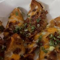 Potato Skins · Jack and cheddar cheese, bacon bits, chives.