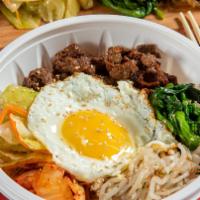Bi Bim Bap · Assorted vegetables and beef on a bed of rice topped with an egg with hot spicy pepper paste...