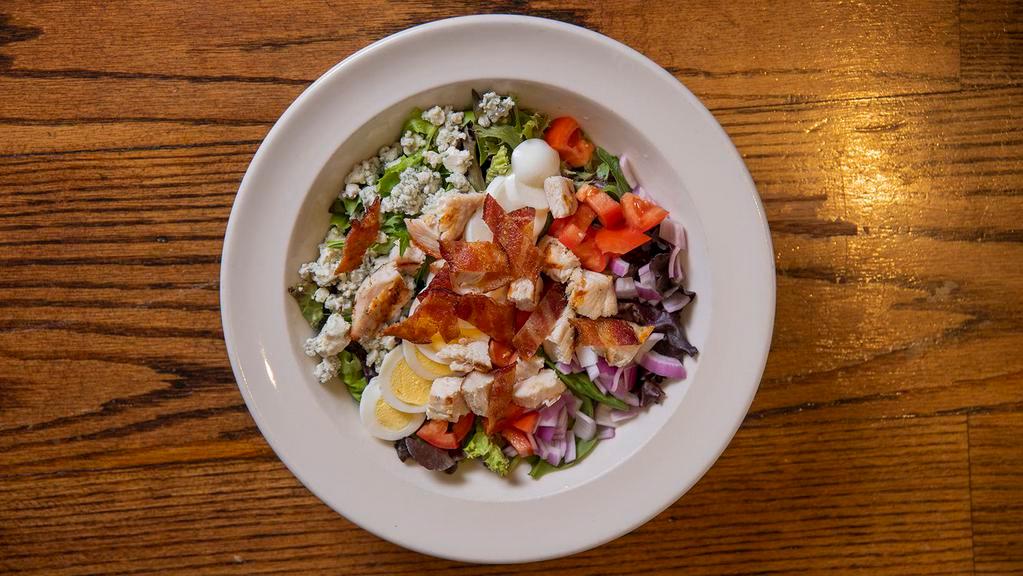 Cobb Salad · Grilled chicken, bacon, blue cheese, tomatoes, onions, hard boiled egg, and mixed greens.