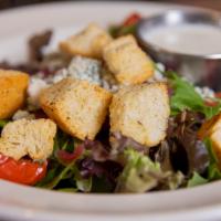 House Salad · Roasted tomatoes, pickled onions, crumbled blue cheese, house made croutons, and mixed greens.