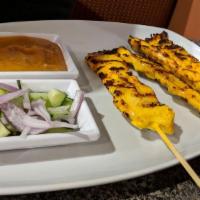 Chicken Satay · Five pieces. Marinated and BBQ meat on skewers with peanut and cucumber sauce.