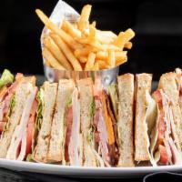 Tree House Club Sandwich · A huge tower of turkey, ham, bacon, cheddar, Jack, avocado, tomato, lettuce, aioli, mayo and...