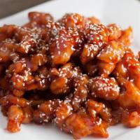 Sesame Chicken · Battered and fried chicken breast pieces, wok-tossed in a sweet and tangy glaze, then topped...
