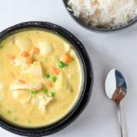Yellow Curry · With coconut milk, potatoes, peas, carrots, and onions.