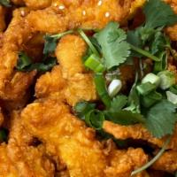 Orange Chicken · Fried chicken breaded in flour and topped with green onions, sesame seed, and orange sauce.