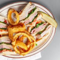 Club Sandwich · Choice of bread, mayo, lettuce, tomato, turkey, ham and bacon with fries.