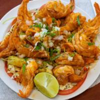 Shrimp Botana · Cabbage, avocado, tomatoes, onions, cilantro and 12 sauteed shrimps.