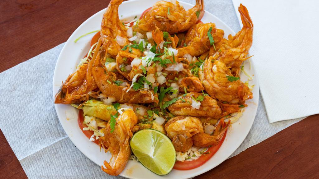 Shrimp Botana · Cabbage, avocado, tomatoes, onions, cilantro and 12 sauteed shrimps.