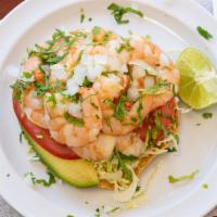 Shrimp Tostada · Sour cream, tomatoes, avocado, onions, cilantro, lime and sliced shrimps.