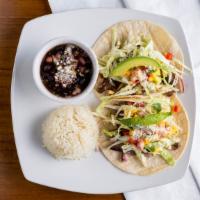 Tacos De Filet Mignon · Two corn tortillas with grilled filet mignon, mushrooms, onions, cabbage, lime oil, and trop...