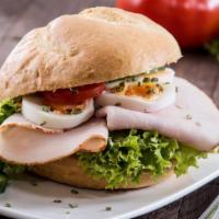 The Turkey Breast Sandwich · Fresh turkey breast slices with lettuce, tomatoes, onions, mustard and mayonnaise.