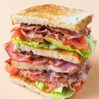 The Super B.L.T Sandwich · Crispy bacon strips, avocado, swiss and american cheese, lettuce, tomatoes, mayonnaise on cu...
